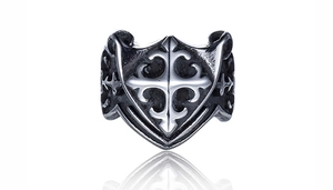 Close-up of vintage steel ring with gothic shield design and embossed cross details