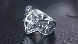 Macro view of vintage shield ring with gothic cross motif in distressed steel finish