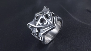 Macro detail of gothic stainless steel ring featuring intricate shield cross engraving