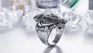 Macro detail of gothic crown and cross motifs on vintage stainless steel ring
