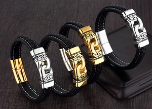 Detailed macro view of woven leather bracelets featuring polished gold and silver magnetic clasps