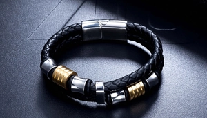 Detail of men's double-layer black braided leather bracelet with gold and silver beads