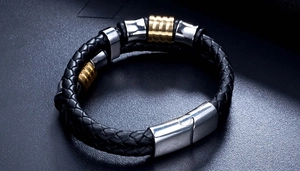 Detail of double-layer black braided leather bracelet with gold and silver steel beads