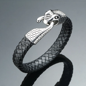 Men's leather bracelet with silver dragon head clasp on a dark reflective surface