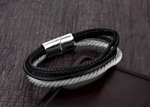 Close-up of punk style multi-layer leather cord bracelet with silver magnetic metal clasp