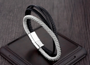 Detail of multi-layer braided leather bracelet with silver magnetic metal clasp