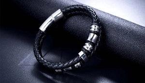 Detailed view of black braided leather men's bracelet with polished silver magnetic clasp