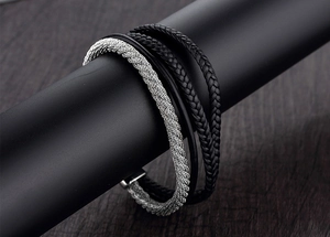 Detailed close-up of multi-layer punk leather bracelet with silver woven steel bands