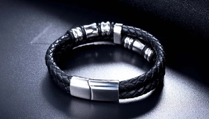 Detail of black braided leather bracelet with silver stainless steel magnetic clasp