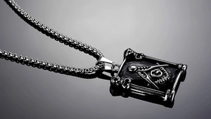 Macro shot of a punk Freemason pendant with a silver square frame and skull details