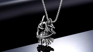 Detailed view of gothic grim reaper pendant with scythe and vintage silver finish