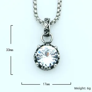 Macro detail of crown-style titanium steel pendant with clear round zircon and vintage engravings