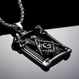 Vintage stainless steel Freemasonry necklace with raven skull frame on mirror background