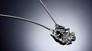 Macro shot of stainless steel Grim Reaper skull pendant with vintage oxidized details
