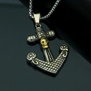 Detailed view of retro anchor pendant featuring a golden skull and vintage steel finish