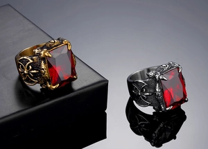 Macro detail of gothic viking rings with red gemstones and cross relief carvings