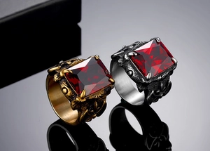 Detail of vintage Viking rings with red gemstones and intricate dragon scale textures