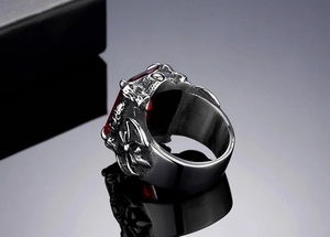 Detailed macro shot of vintage Viking ring featuring a red gemstone and cross carvings