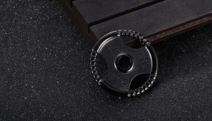 Macro shot of titanium steel mini dumbbell plate pendant with 45 LBS and Go Fit engraving