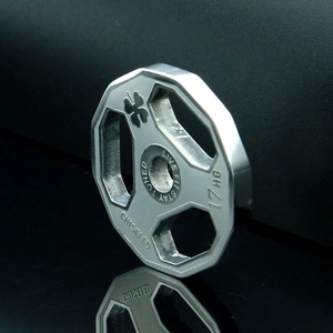 Macro shot of octagonal barbell plate pendant with Chiseled and Live Fit engraving