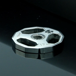 Macro shot of stainless steel dumbbell plate pendant with Live Fit Stay Toned engraving