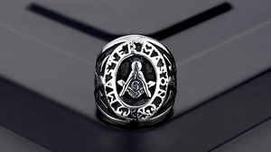 Macro view of Master Mason Freemasonry ring with vintage steel texture and G symbol
