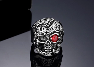 Macro shot of gothic raven skull ring with red ruby eye and sparkling zircon pavé