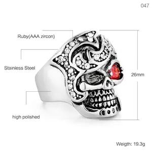 Gothic skull ring in polished stainless steel with red ruby eyes and clear zircon stones