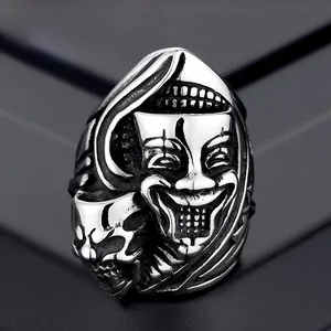Macro shot of retro gothic steel ring featuring detailed skull and clown mask designs