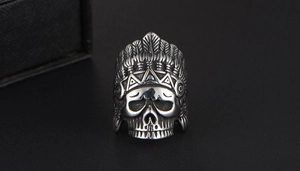 Macro shot of punk style stainless steel ring featuring detailed Indian chief skull carving