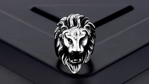 Macro detail of carved lion head ring with vintage texture and polished titanium steel