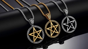 Detailed view of silver and gold pentagram pendants with hollow moon on a box chain