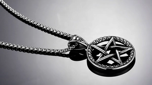 Macro shot of stainless steel pentagram pendant with vintage textured link chain