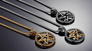 Detailed view of hollow pentagram moon pendants in black, gold, and silver finishes