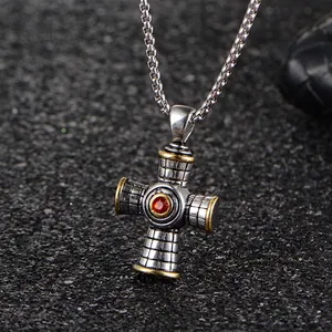Gothic stainless steel cross pendant with red gemstone and two-tone gold edges