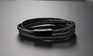 Macro shot of multi-layer black braided leather bracelet with magnetic metal clasp