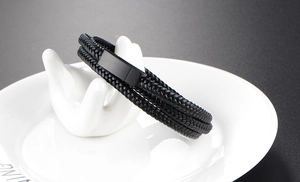 Close-up of triple-layer braided leather bracelet with black matte metal magnetic clasp