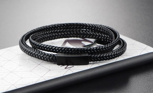 Close-up of black multi-layer braided leather bracelet with matte black metal magnetic clasp