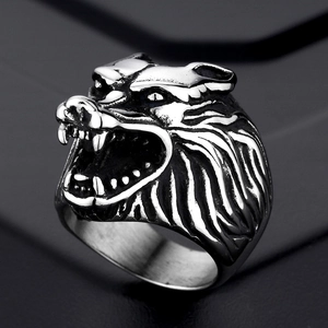 Macro detail of silver titanium steel wolf head ring with intricate vintage engraving