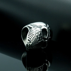 Polished silver skull ring with US flag engraving on side, punk rocker accessory for men