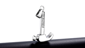 Macro shot of silver hammer pendant featuring anti-slip texture and polished steel finish