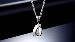Macro shot of a punk style stainless steel grenade pendant with detailed metal texture