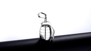 Polished silver stainless steel grenade pendant shown on a minimalist black stand