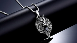 Detailed view of titanium steel wolf head pendant with black gemstone and box chain