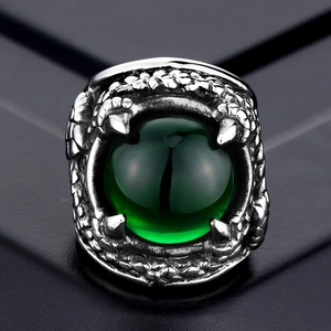 Gothic punk dragon claw ring with a large green gemstone eye in vintage titanium steel