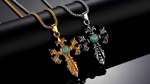 Detailed close-up of retro gothic cross pendants with turquoise inlay and fleur-de-lis