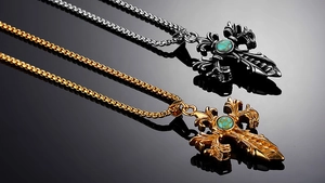 Detailed macro view of vintage cross pendants with turquoise stones and baroque engravings