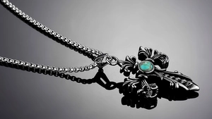 Detailed close-up of a vintage gothic steel cross pendant with turquoise inlay detail