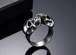 Macro shot of twin skull ring in vintage silver finish with detailed facial engravings