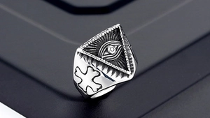 Macro shot of 316L stainless steel vintage punk ring with Eye of Providence and cross detail